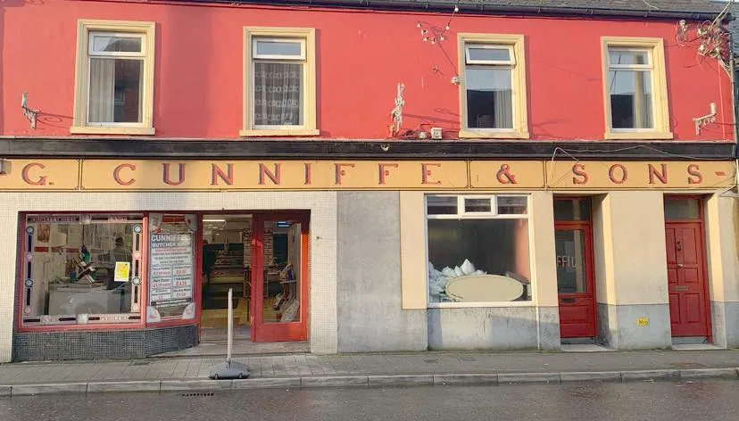 G. Cunniffe & Sons shopfront on Main Street Ballaghaderreen with bold red facade and gold signage